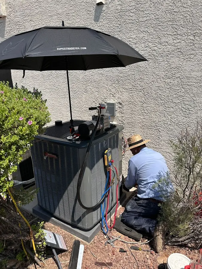 HVAC technician performing outdoor AC maintenance in Goldenrod